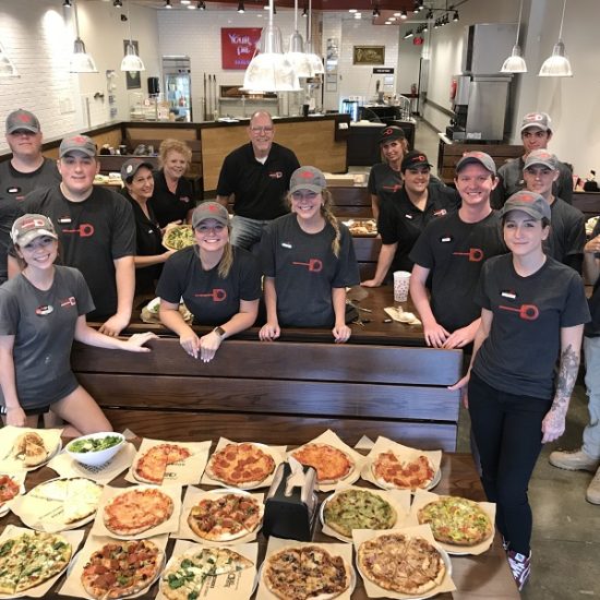 group of your pie pizza restaurant employees - cost of opening a pizza franchise