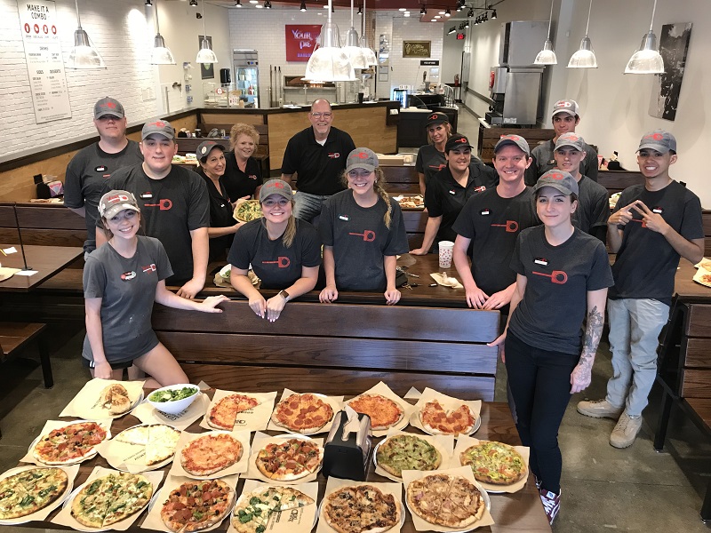group of your pie pizza restaurant employees - cost of opening a pizza franchise