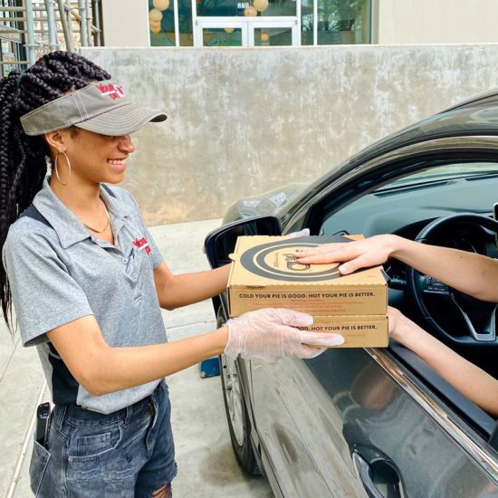 your pie pizza restaurant franchise employee delivering pizza to curbside