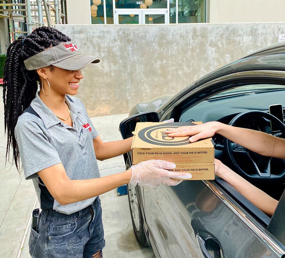 your pie pizza restaurant franchise employee delivering pizza to curbside
